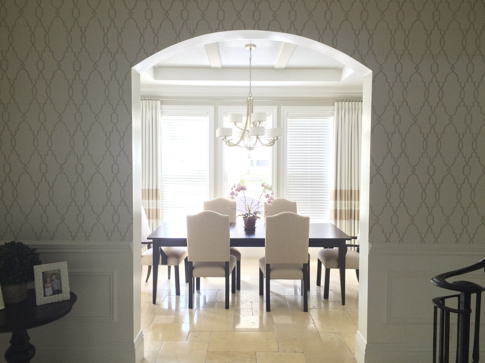 a peek into dining space with beautiful wallpaper