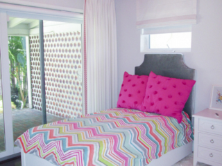 bright accent girls bedroom with white furniture