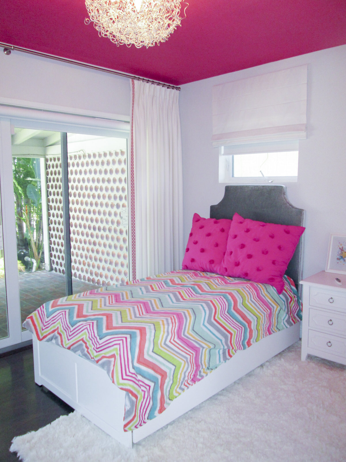 bright accent girls bedroom with white furniture
