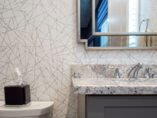 close up bathroom sink and wallpaper