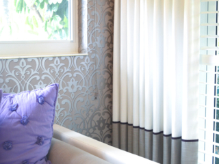 close up of luxury girls room bed pillows drapes and wallpaper