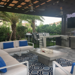 custom outdoor lounging pavillion with kitchen and tv