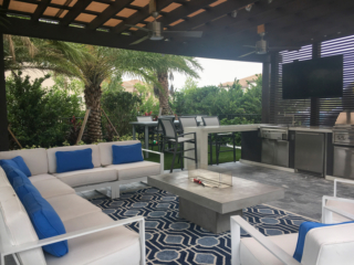 custom outdoor lounging pavillion with kitchen and tv