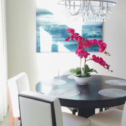 details of dining space with bright colored orchid center piece