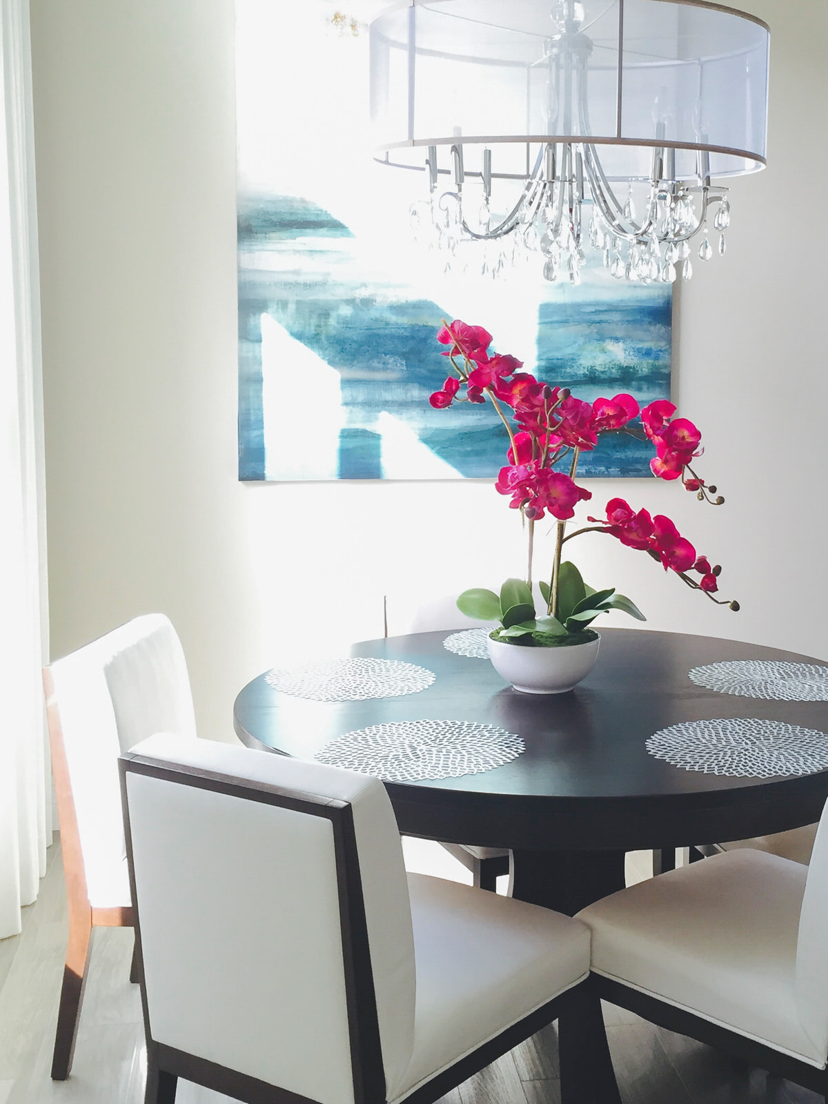 details of dining space with bright colored orchid center piece