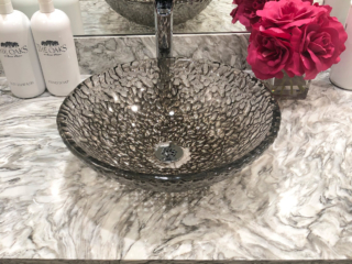 glass bowl sink with pop of pink flower accent