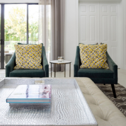 green chairs with yellow pillows pop on neutral backdrop