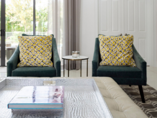 green chairs with yellow pillows pop on neutral backdrop