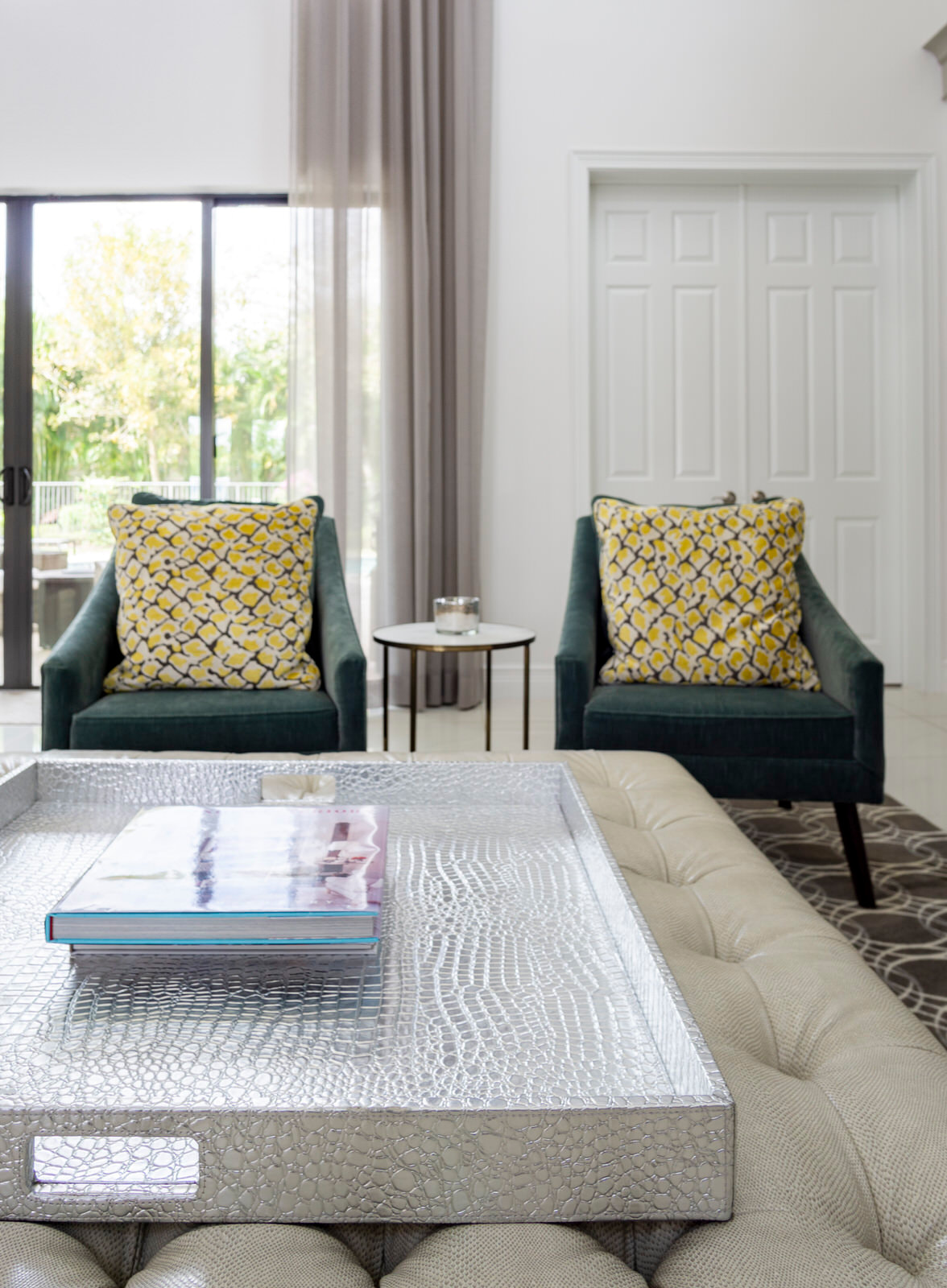 green chairs with yellow pillows pop on neutral backdrop