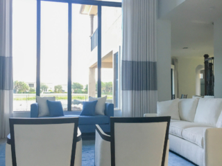 living space with large windows and custom drapes