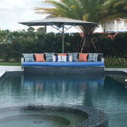 lounging area at edge of pool with umbrella