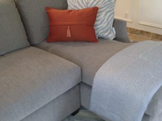 neutral patterns and orange pop living room