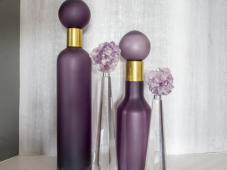 purple and gold bottles with grey wallpaper