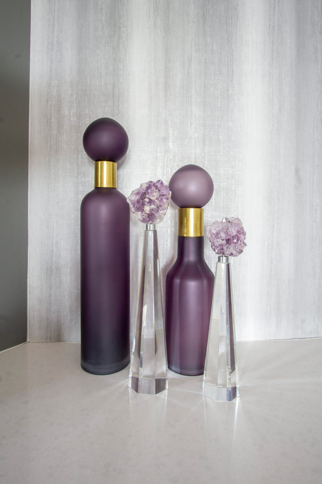 purple and gold bottles with grey wallpaper